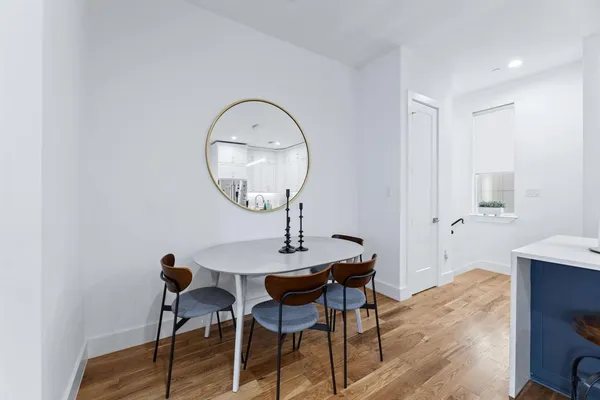a kitchen with stainless steel appliances granite countertop a sink a stove and white cabinets