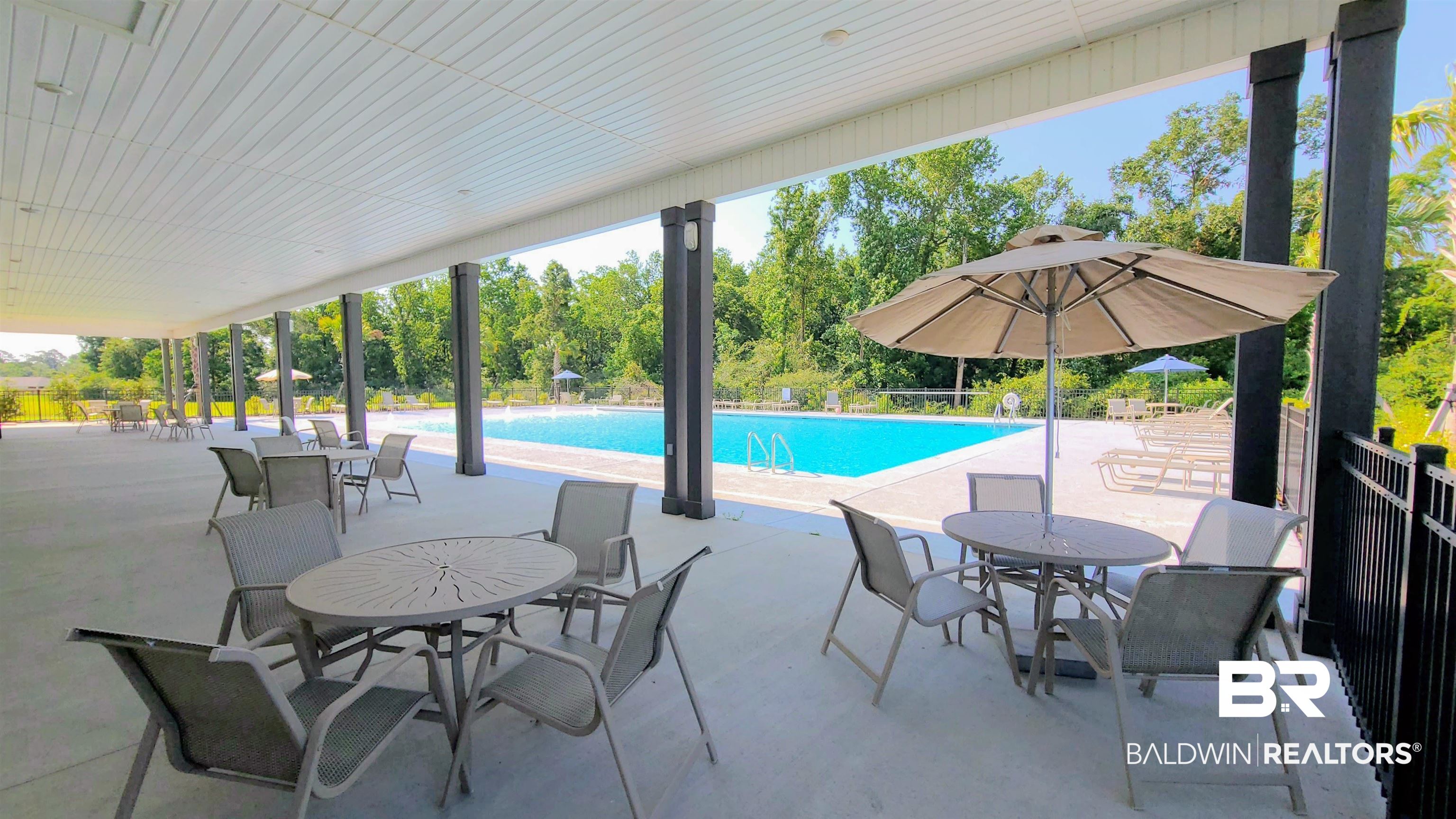 22019 Aleutian Avenue Foley, AL 36535 - Photo 16 of 17 Community pool with a patio area and view of scattered trees
