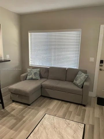 a living room with furniture and a window