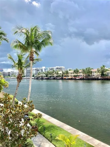 a view of a pool with lawn chairs in front of it