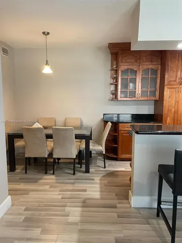 a living room with chairs and a table