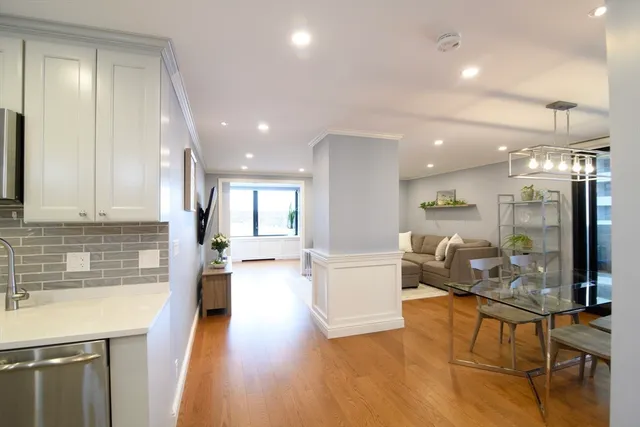 a living room with fireplace furniture and a wooden floor
