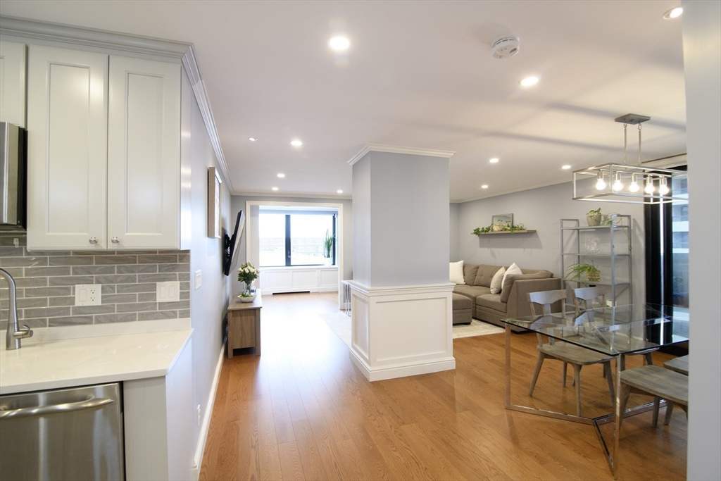 65 East India Row, Unit 9C Boston, MA 02110 - Photo 11 of 40 a living room with fireplace furniture and a wooden floor