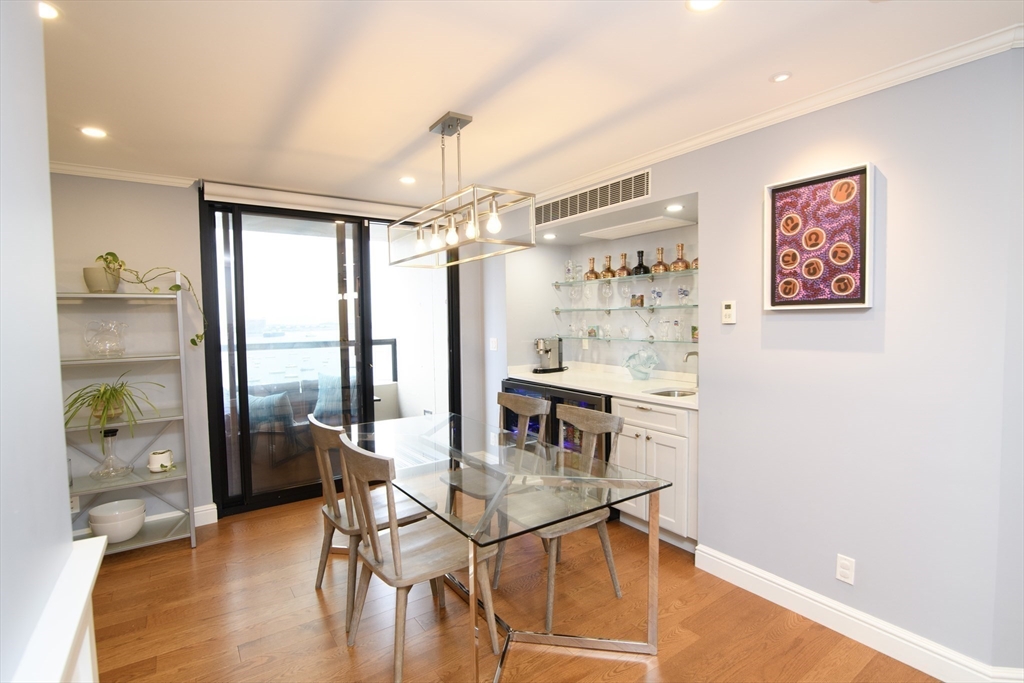 65 East India Row, Unit 9C Boston, MA 02110 - Photo 12 of 40 a view of a livingroom with furniture window and wooden floor