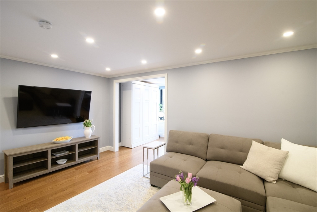 65 East India Row, Unit 9C Boston, MA 02110 - Photo 14 of 40 a living room with furniture and a flat screen tv