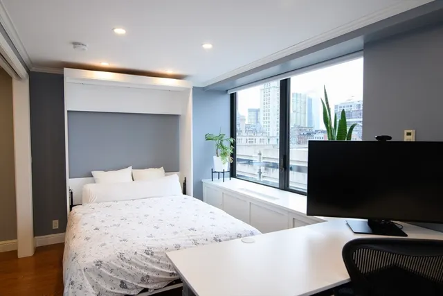 a bedroom with a bed and glass window