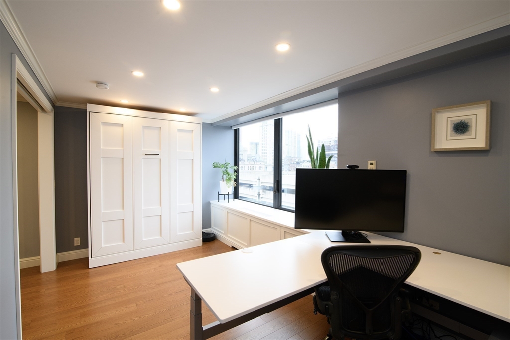 65 East India Row, Unit 9C Boston, MA 02110 - Photo 17 of 40 a view of a workspace with furniture and a window