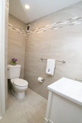 a bathroom with a toilet a sink and shower