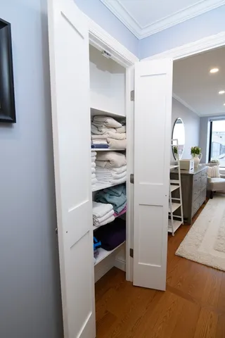 a view of walk in closet with clothes and shoes