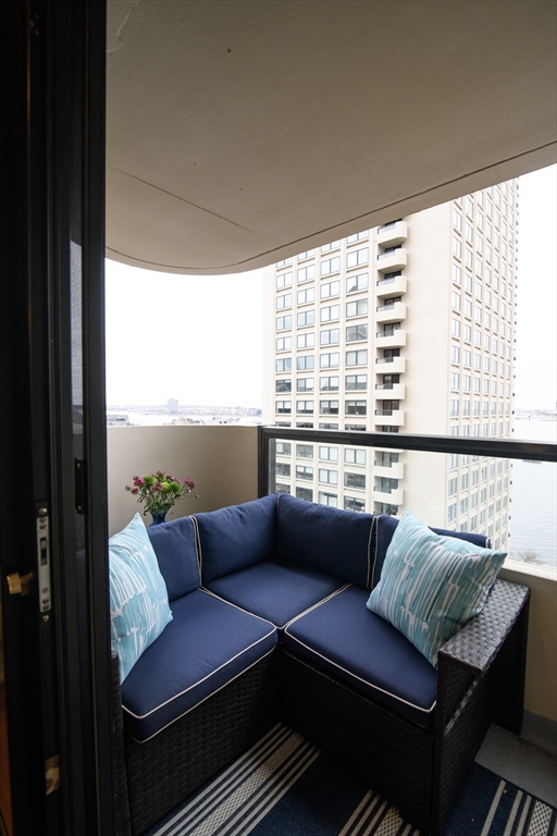 65 East India Row, Unit 9C Boston, MA 02110 - Photo 29 of 40 a living room with furniture and a window