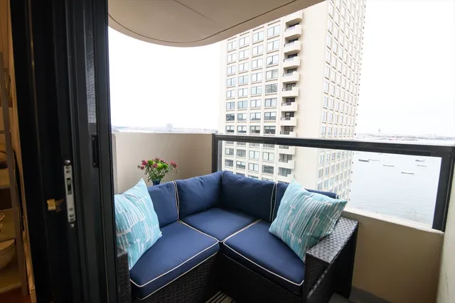 a view of a patio with table and chairs potted plants and palm tree