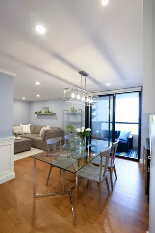 a dining room with furniture and a wooden floor
