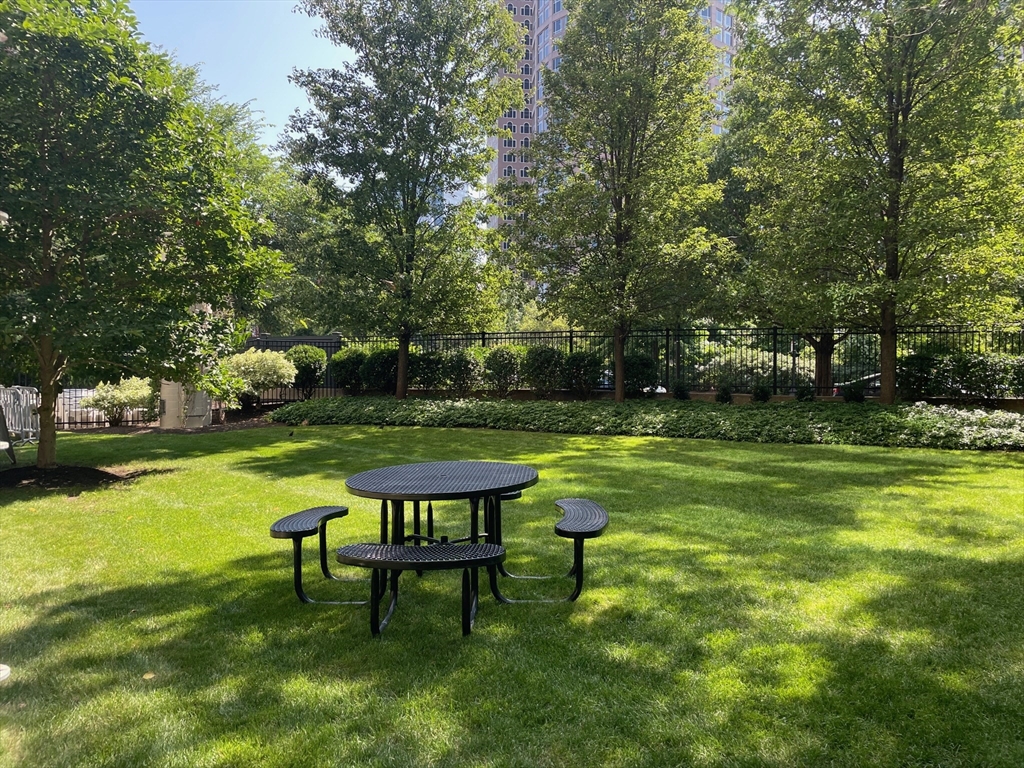 65 East India Row, Unit 9C Boston, MA 02110 - Photo 33 of 40 a view of a table and chairs in the garden