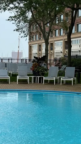a view of roof deck with wooden floor and fence