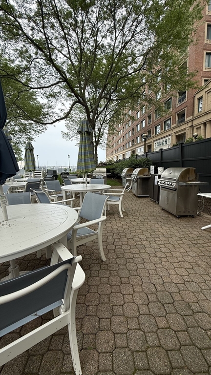 65 East India Row, Unit 9C Boston, MA 02110 - Photo 37 of 40 a view of a patio with table and chairs and couches