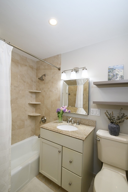 65 East India Row, Unit 9C Boston, MA 02110 - Photo 8 of 40 a bathroom with a sink a toilet and shower