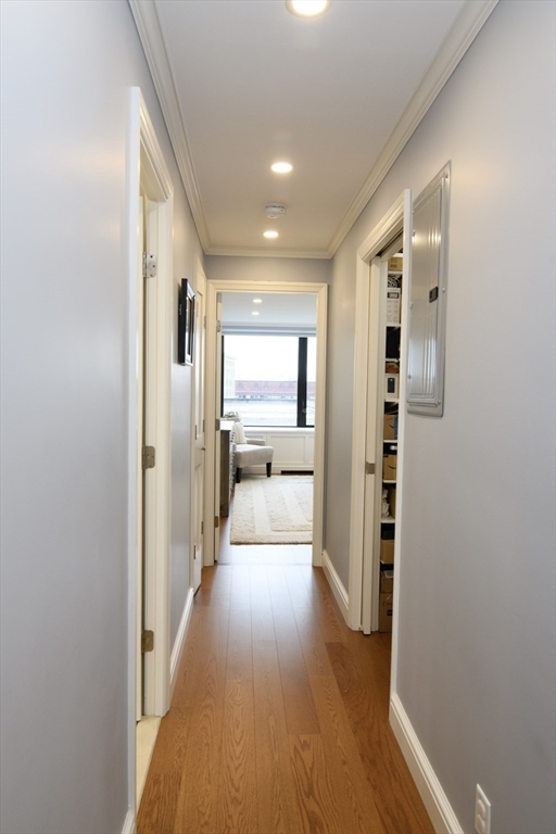 65 East India Row, Unit 9C Boston, MA 02110 - Photo 9 of 40 a view of a hallway with wooden floor and windows
