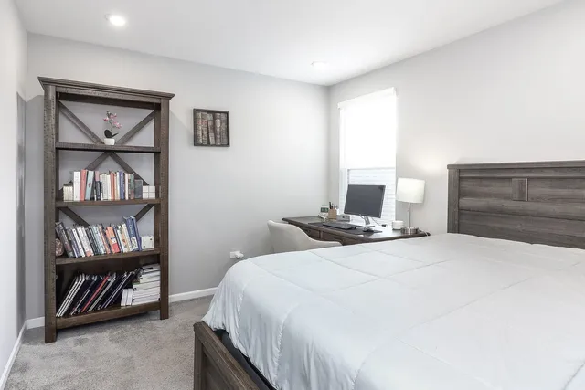 a spacious bedroom with a bed and a couch