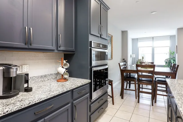 a kitchen with granite countertop a sink and cabinets