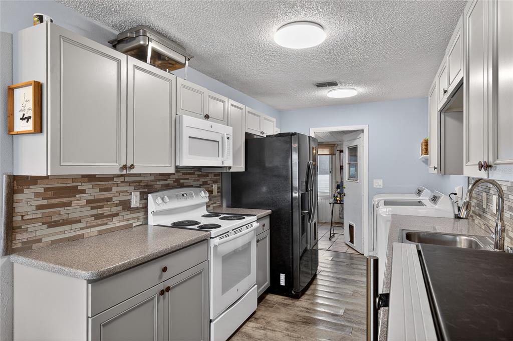 622 Ridge Terrace Winter Haven, FL 33881 - Photo 10 of 29 a kitchen with stainless steel appliances a sink stove and refrigerator