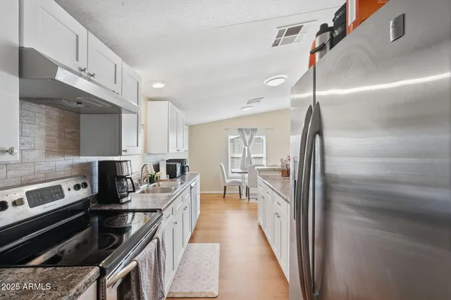 a living room with granite countertop furniture and a flat screen tv