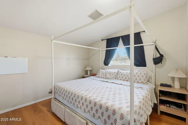 a view of a workspace with furniture and wooden floor