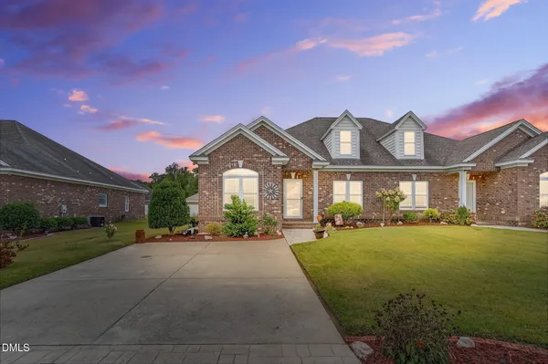 a front view of a house with a yard