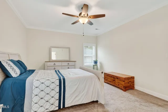 a spacious bedroom with a bed and window