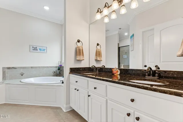 a bathroom with a sink a vanity a mirror and a bathtub