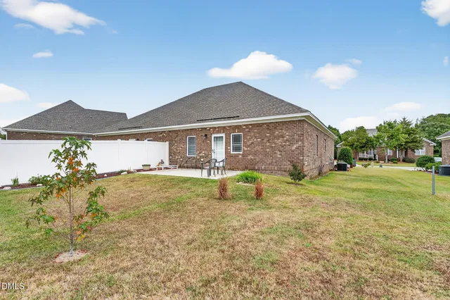 a view of a house with a backyard