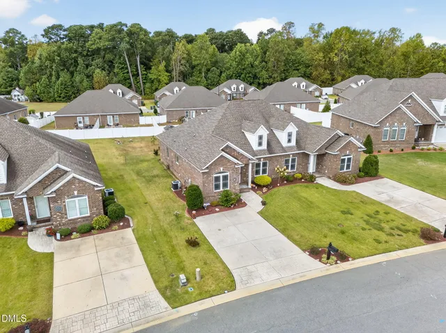 an aerial view of a house with a yard