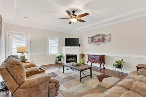 a living room with furniture and kitchen view