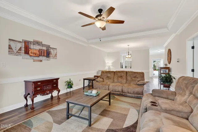 a living room with furniture and kitchen view