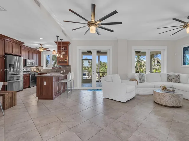 a living room with furniture a window and a flat screen tv