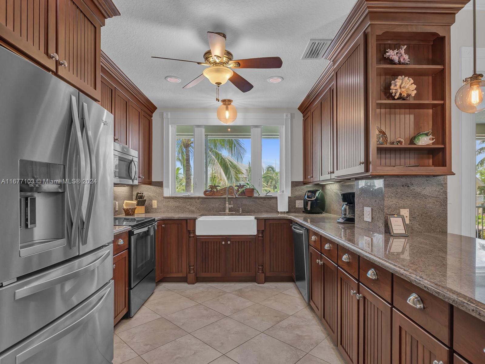 3 North Drive Key Largo, FL 33037 - Photo 20 of 54 a kitchen with stainless steel appliances granite countertop a refrigerator and a sink