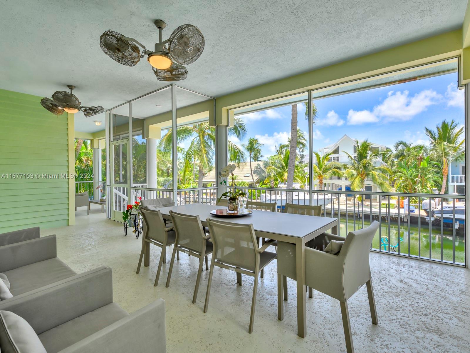 3 North Drive Key Largo, FL 33037 - Photo 23 of 54 a dining room with furniture a large window and a rug