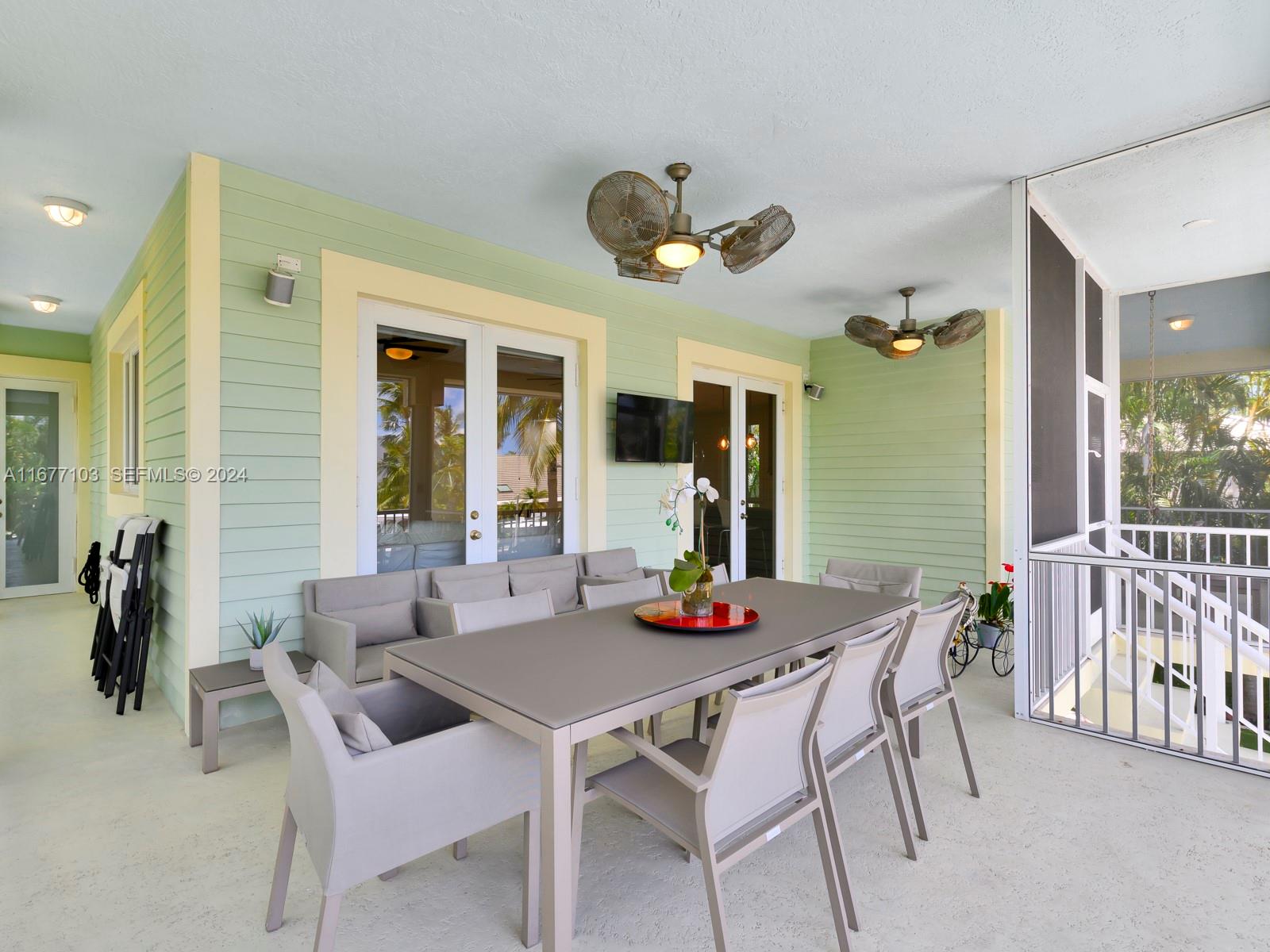 3 North Drive Key Largo, FL 33037 - Photo 24 of 54 a view of a dining room with furniture and wooden floor