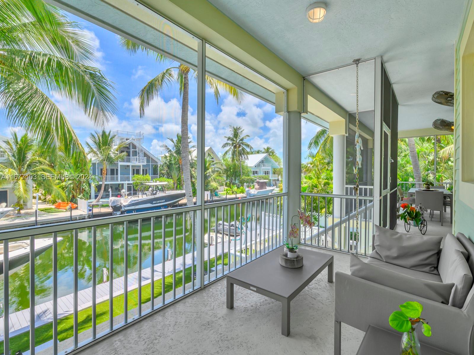 3 North Drive Key Largo, FL 33037 - Photo 25 of 54 a view of a porch with chairs and a potted plant