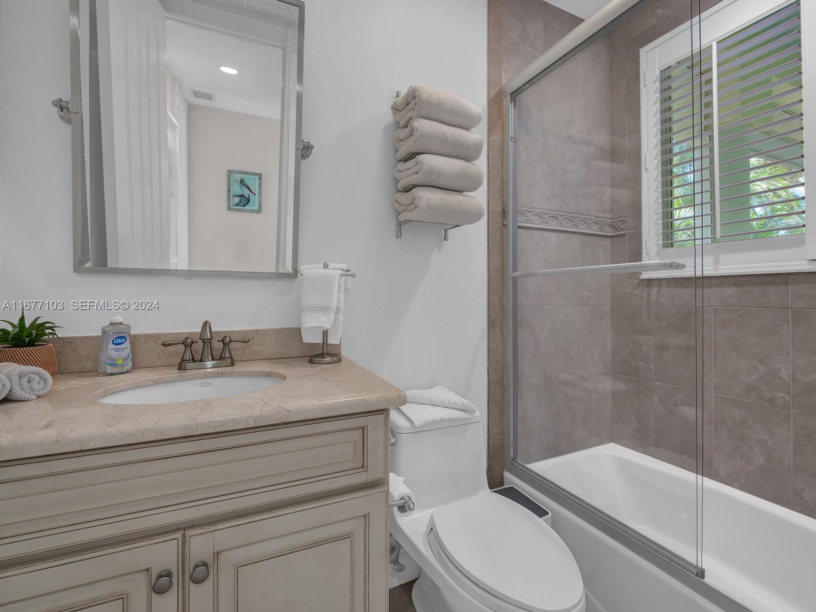 3 North Drive Key Largo, FL 33037 - Photo 27 of 54 a bathroom with a granite countertop toilet sink and mirror