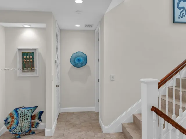 a bedroom with a bed and a view of ceiling fan