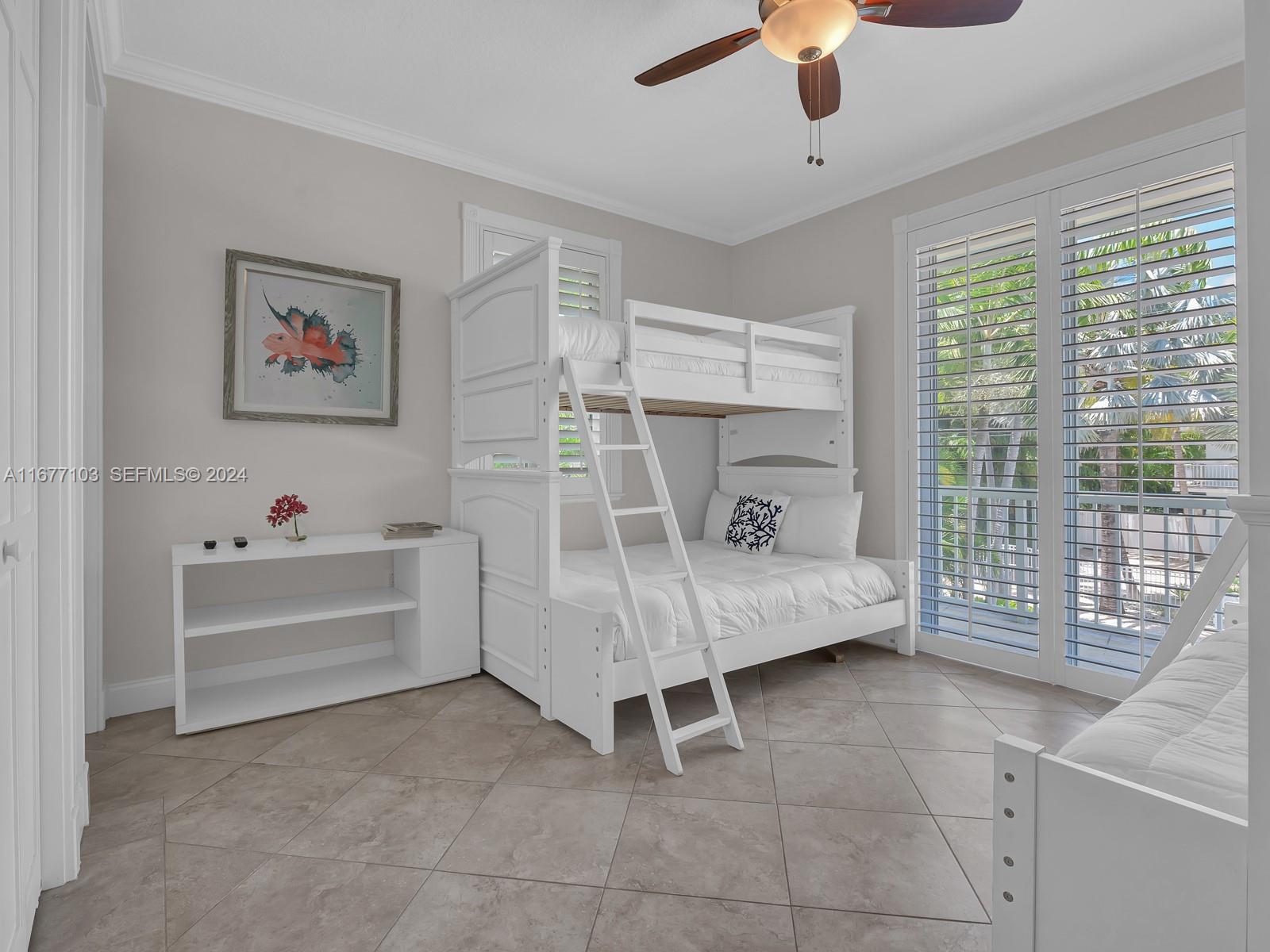 3 North Drive Key Largo, FL 33037 - Photo 30 of 54 a spacious bedroom with a bed and a chandelier