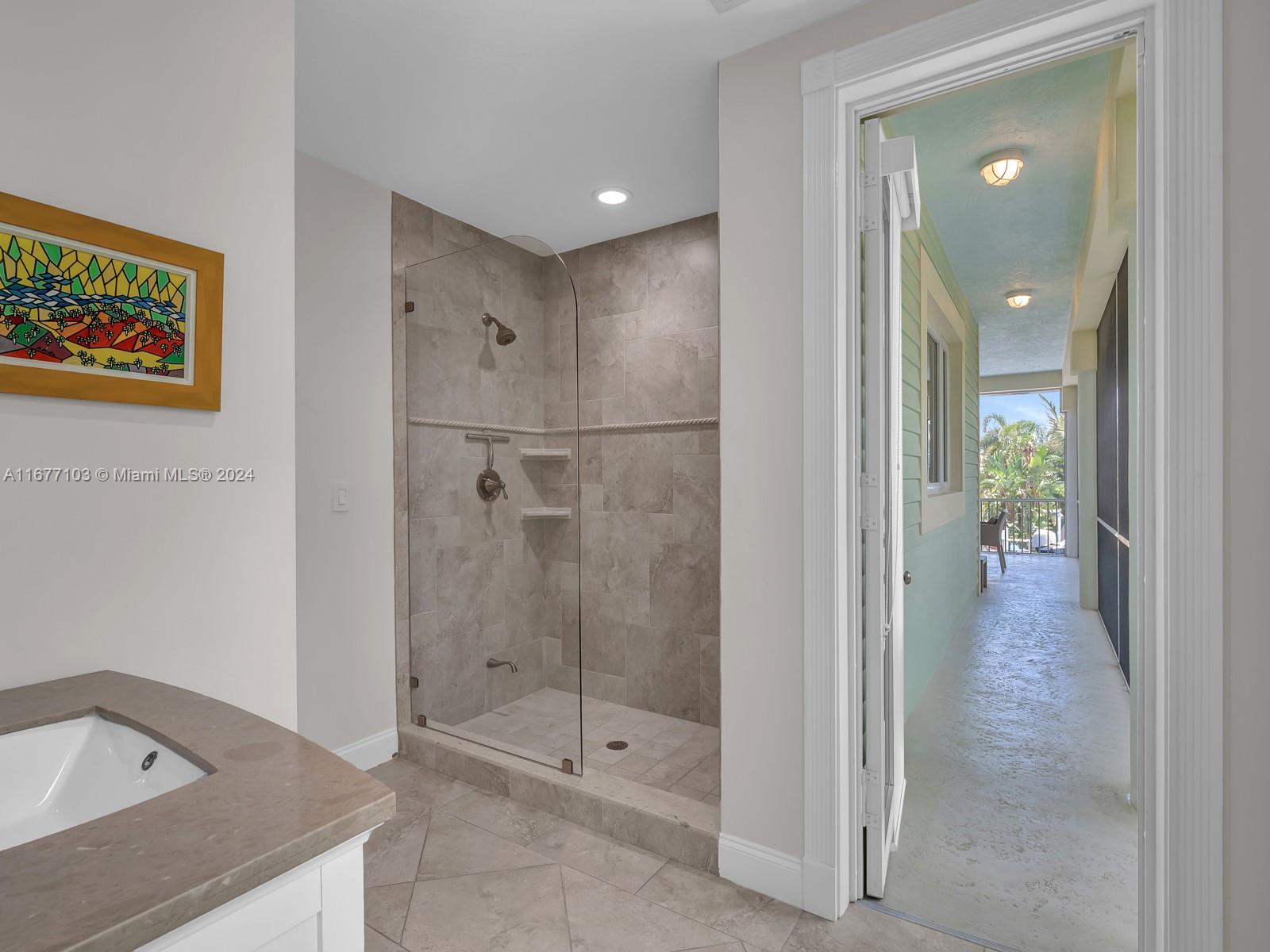 3 North Drive Key Largo, FL 33037 - Photo 32 of 54 a bathroom with a granite countertop sink mirror and shower