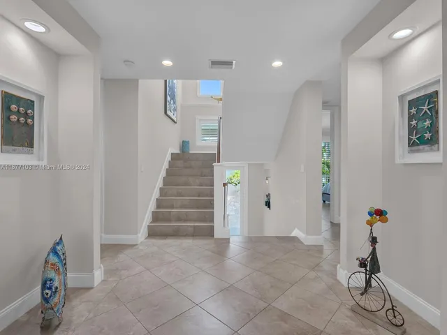 a bedroom with a bed and a ceiling fan