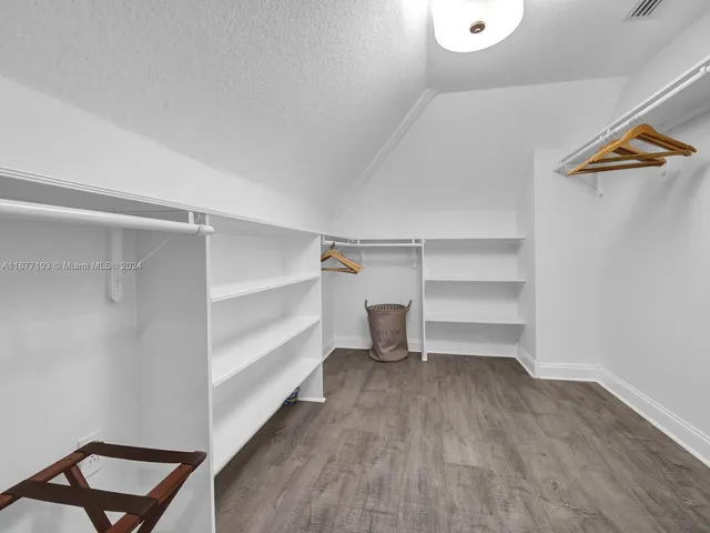 a spacious bedroom with a bed and a couch