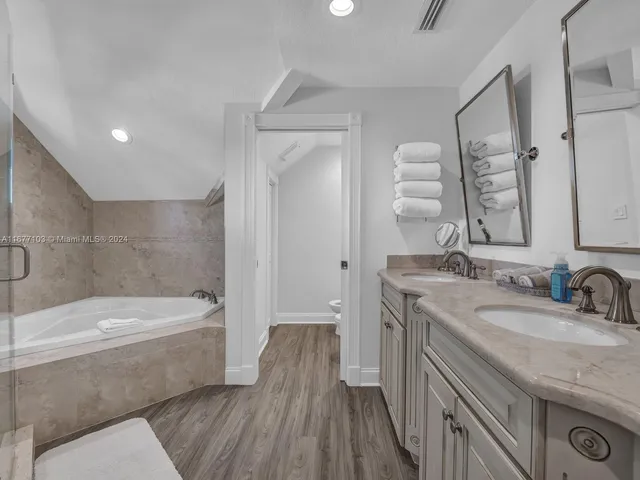 a spacious bedroom with a bed and a couch