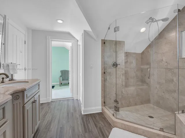 a bathroom with a double vanity sink toilet and shower