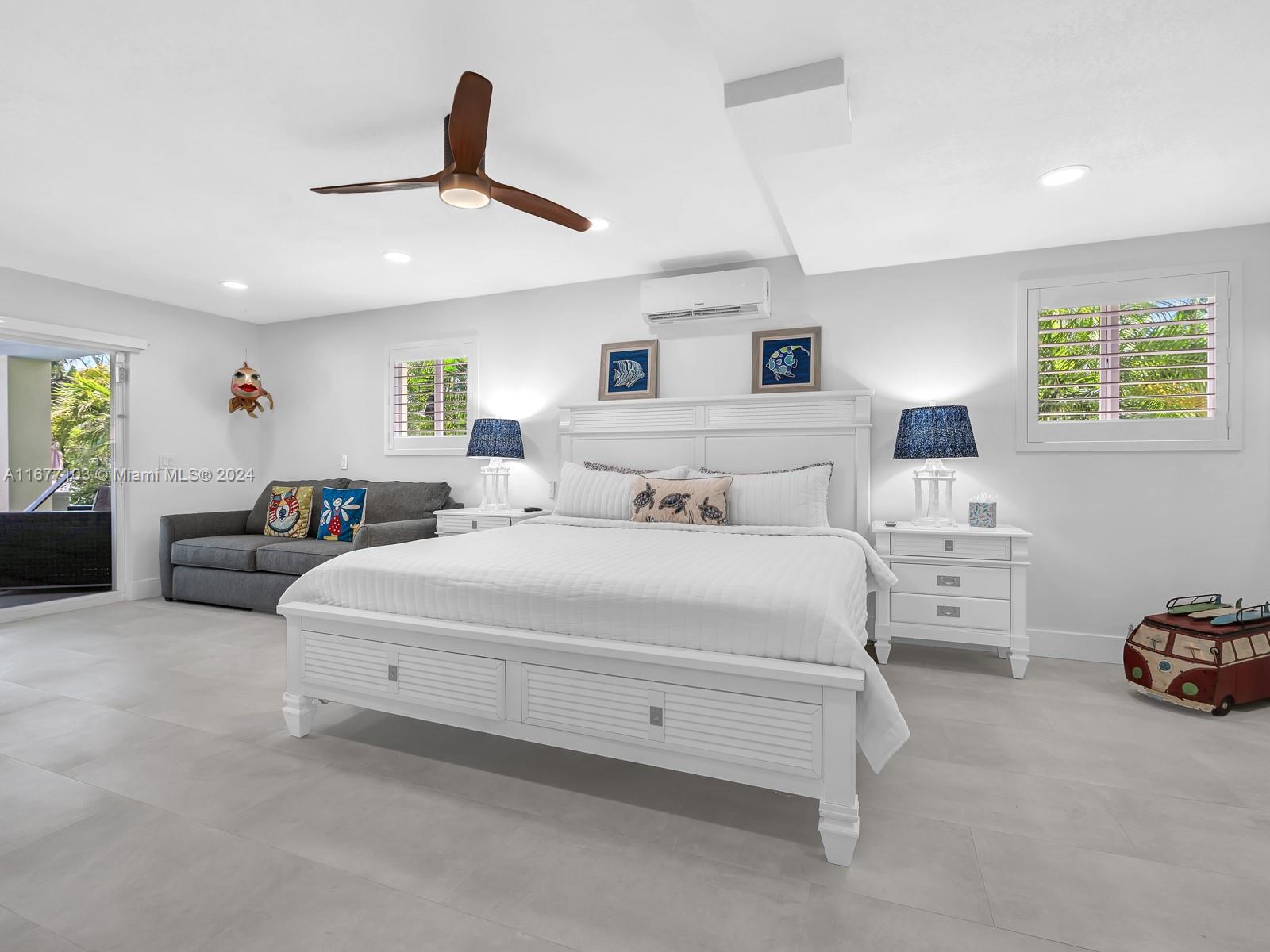 3 North Drive Key Largo, FL 33037 - Photo 44 of 54 a spacious bedroom with a bed and a couch