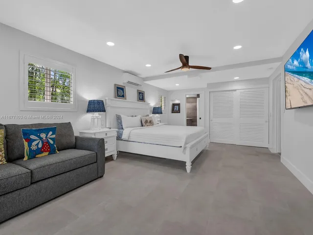 a living room with couches and a large window with outer view