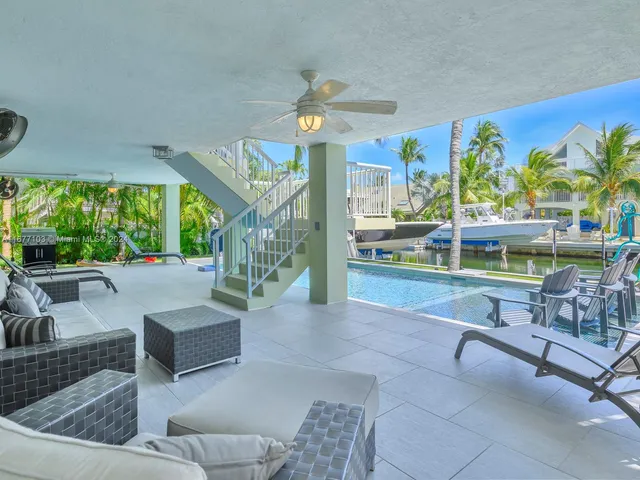 a view of a house with swimming pool and sitting area