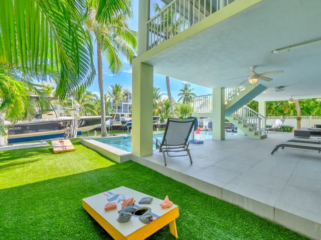 a view of an house with backyard and sitting area